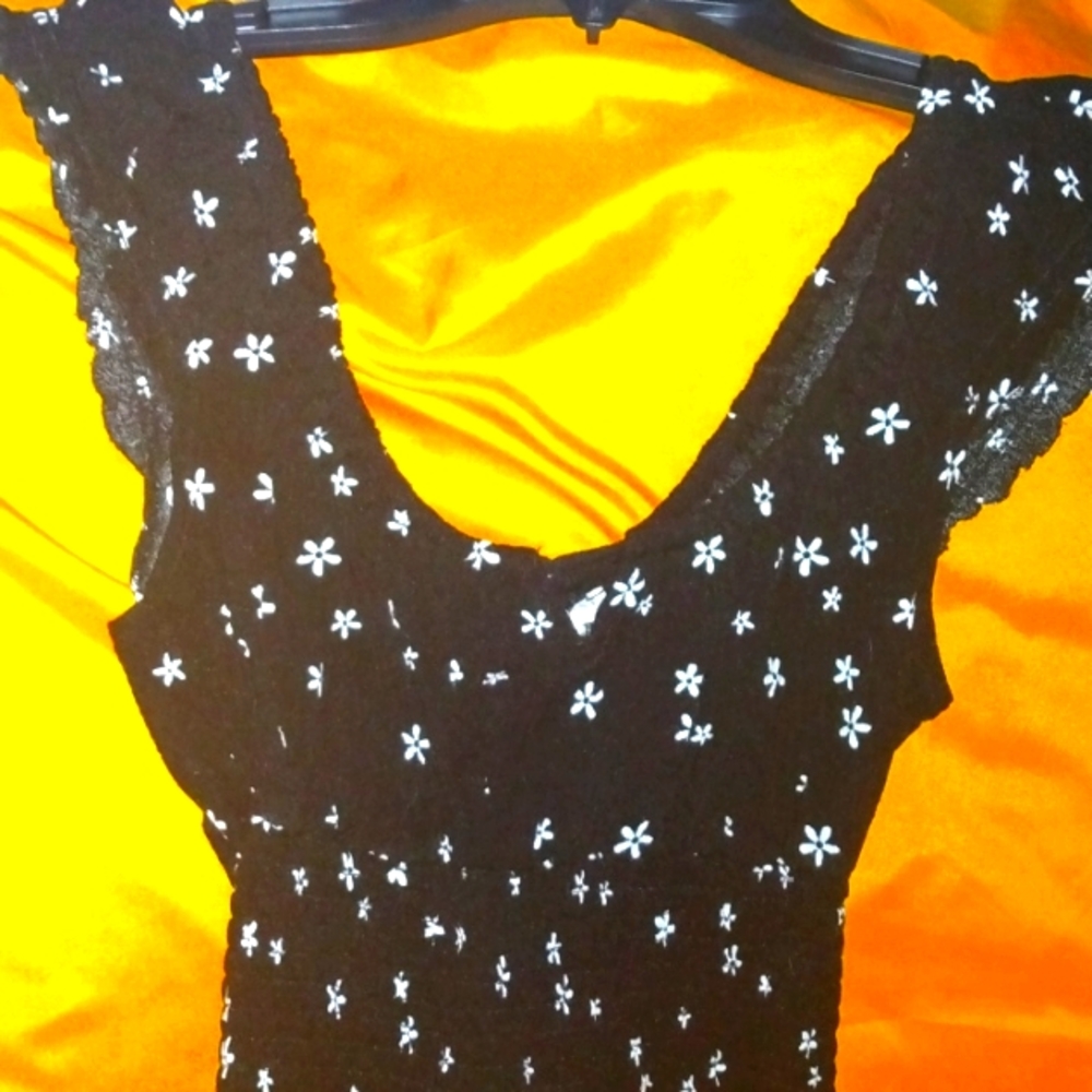 Super Cute tight fitting black crop top with little white daisy's